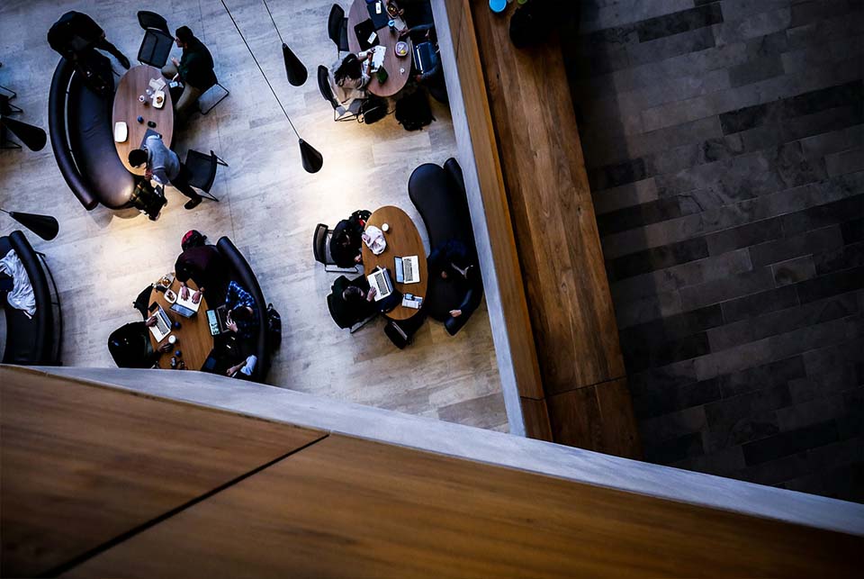 College students sitting at tables studying together in a university setting, representing campus life and student safety in Georgia
